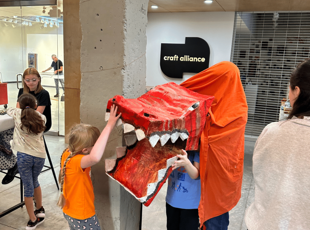 Summer Camp Default Photo - Kids playing with a large dragon puppet they created in camp