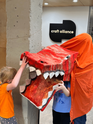 Summer Camp Default Photo - Kids playing with a large dragon puppet they created in camp